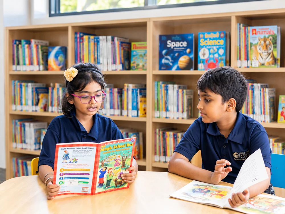 Primary students reading in the library