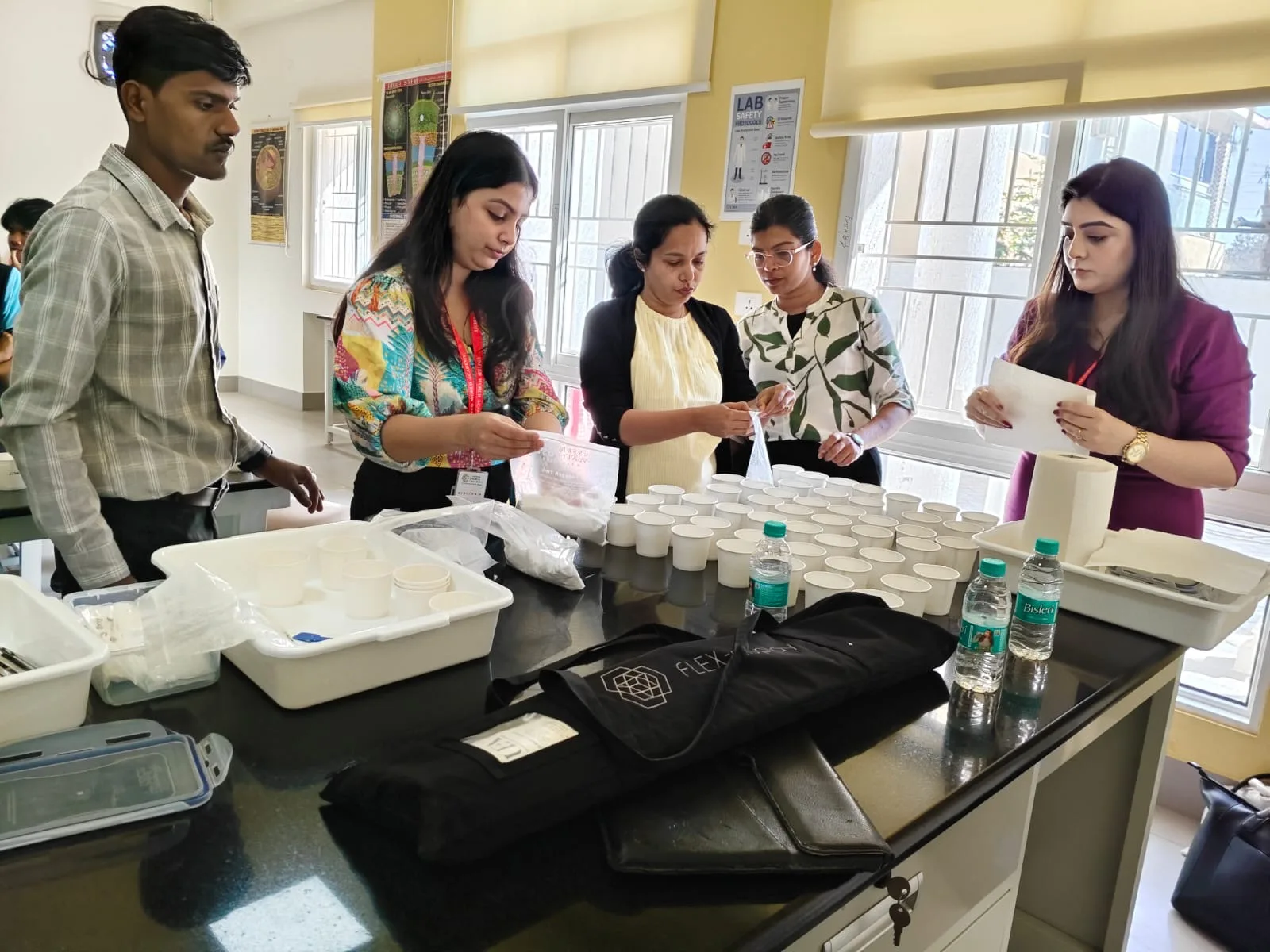 Students with visiting university representatives at a hands-on workshop
