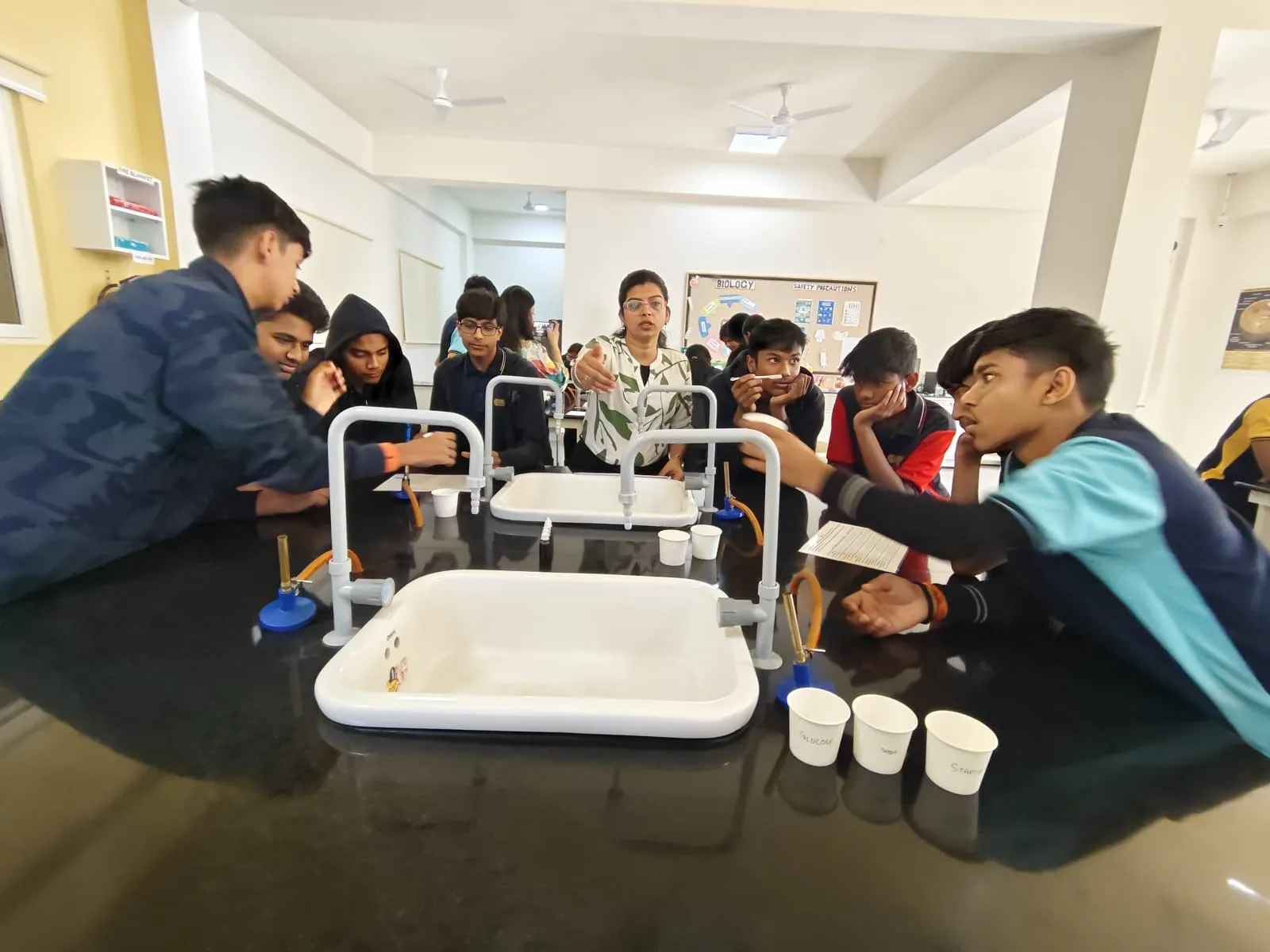 Students gathered around a lab bench during a university masterclass